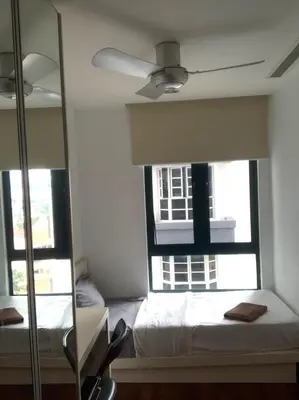 a bedroom with two windows and a bed and a ceiling fan at Casa Residency apartment by Classy Homes in Kuala Lumpur