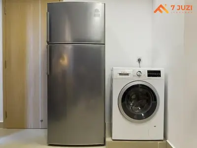 a stainless steel refrigerator next to a washing machine at KL &118 Tower View 1R1B Netflix 19F & Best View Infinity Pool in Kuala Lumpur