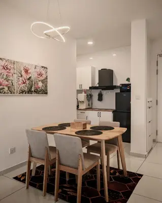 a kitchen with a table and chairs in a room at View KLCC 3 Bedroom Homestay Kenwingston Platz in Kuala Lumpur