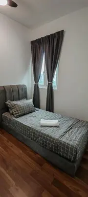 a bed sitting in a bedroom with a window at Puncak Sentul KL with 3 Bedroom Homestay in Kuala Lumpur
