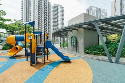 a playground with a slide in front of a building at Puncak Sentul KL with 3 Bedroom Homestay in Kuala Lumpur