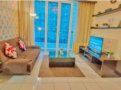 a living room with a couch and a television at Seri Bukit Ceylon Dreamy Destiny luxe Suites in Kuala Lumpur