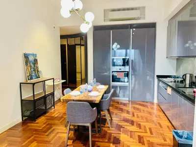 a kitchen and dining room with a table and chairs at KLCC The Mews Luxury suites Malaysia in Kuala Lumpur
