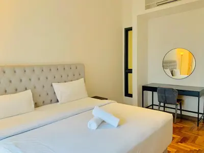 a bedroom with a white bed and a mirror at KLCC The Mews Luxury suites Malaysia in Kuala Lumpur