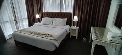 a bedroom with a large bed with a large window at SkS Service suite at times square in Kuala Lumpur