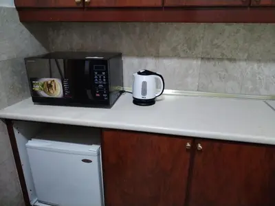 a microwave sitting on top of a kitchen counter at SkS Service suite at times square in Kuala Lumpur