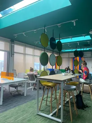 a group of people sitting at tables in an office at City View Retreat in Kuala Lumpur