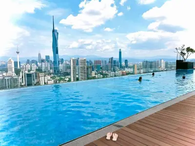 a infinity pool with a view of the city at City View Retreat in Kuala Lumpur