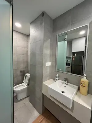 a bathroom with a sink and a toilet and a mirror at City View Retreat in Kuala Lumpur