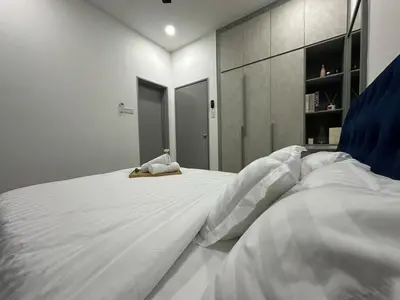a bedroom with two beds with white sheets at KL City 3BR 3Bath Condo , Razak city ,TV box & Pool in Kuala Lumpur