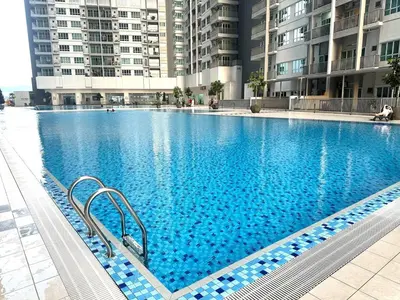 a large blue swimming pool in a building at KL City 3BR 3Bath Condo , Razak city ,TV box & Pool in Kuala Lumpur