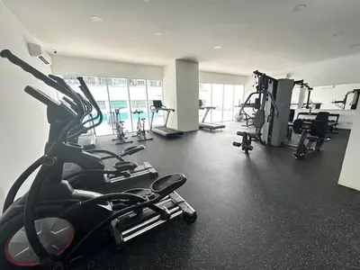 a gym with several treadmills and machines in it at Simple Comforts KL Shared apt in Kuala Lumpur