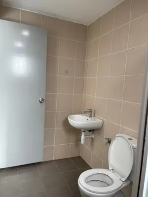 a bathroom with a toilet and a sink at Simple Comforts KL Shared apt in Kuala Lumpur