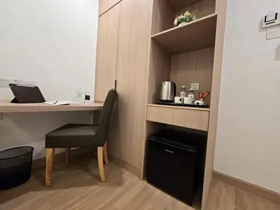 a room with a desk with a chair and a laptop at Seko Suites by Aurelius Chow Kit in Kuala Lumpur