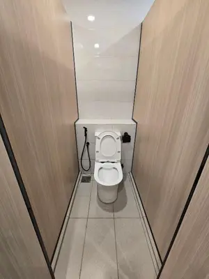a small bathroom with a toilet in a stall at Seko Suites by Aurelius Chow Kit in Kuala Lumpur