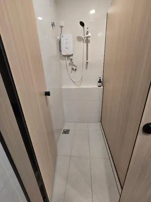 a bathroom with a shower and a toilet at Seko Suites by Aurelius Chow Kit in Kuala Lumpur