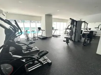 a gym with several treadmills and exercise bikes at Modern High-Floor 2BR Retreat 9km to KL City Centre in Kuala Lumpur