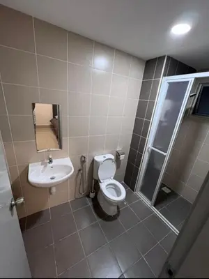 a bathroom with a toilet and a sink at Modern High-Floor 2BR Retreat 9km to KL City Centre in Kuala Lumpur