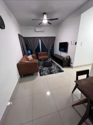 a living room with a couch and a tv at Modern High-Floor 2BR Retreat 9km to KL City Centre in Kuala Lumpur
