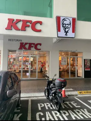a motorcycle parked in front of a kfc store at Modern High-Floor 2BR Retreat 9km to KL City Centre in Kuala Lumpur