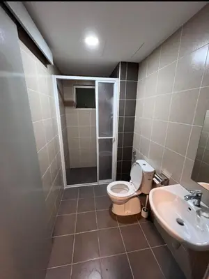 a bathroom with a toilet and a sink at Modern High-Floor 2BR Retreat 9km to KL City Centre in Kuala Lumpur