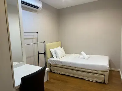 a small room with a bed and a mirror at Bukit Bintang Fairlane suite by Rose in Kuala Lumpur