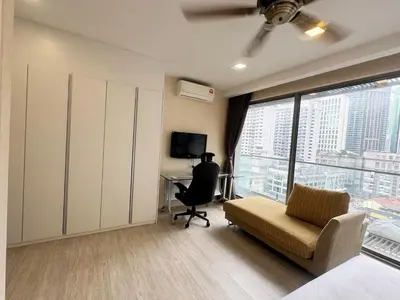 a bedroom with a bed and a desk and a chair at Bukit Bintang Fairlane suite by Rose in Kuala Lumpur