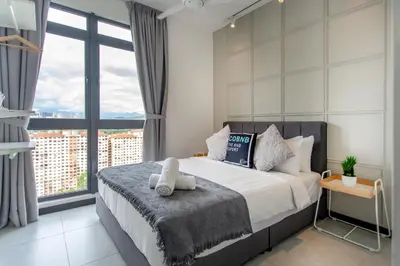 a bedroom with a bed and a large window at Neu Suites Ampang near Gleneagles in Kuala Lumpur