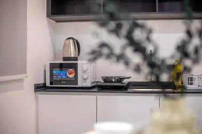 a microwave sitting on a counter in a kitchen at Neu Suites Ampang near Gleneagles in Kuala Lumpur