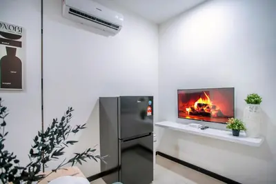 a living room with a fireplace and a refrigerator at Neu Suites Ampang near Gleneagles in Kuala Lumpur