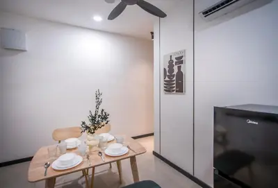a dining room table with plates and a tv at Neu Suites Ampang near Gleneagles in Kuala Lumpur