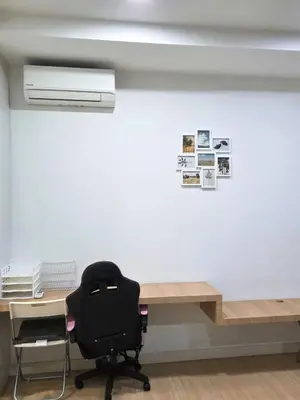 a black chair sitting in front of a desk at Camellia Serviced Suites in Kuala Lumpur