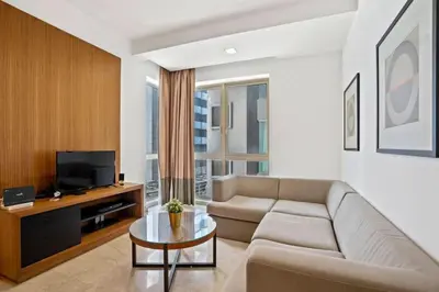 a living room with a couch and a tv at My Habitat KL in Kuala Lumpur