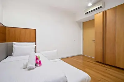 a bedroom with a large white bed with flowers on it at My Habitat KL in Kuala Lumpur