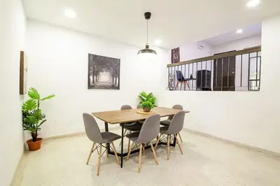 a dining room with a wooden table and chairs at Bukit Damansara Terrace in Kuala Lumpur