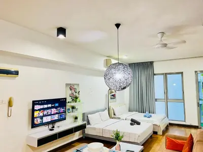 a living room with a couch and a tv at Enjoy your stay Regalia view KLCC in Kuala Lumpur