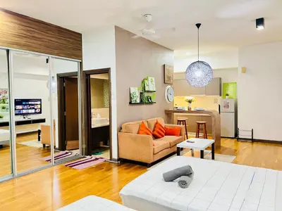 a living room with a couch and a table at Enjoy your stay Regalia view KLCC in Kuala Lumpur