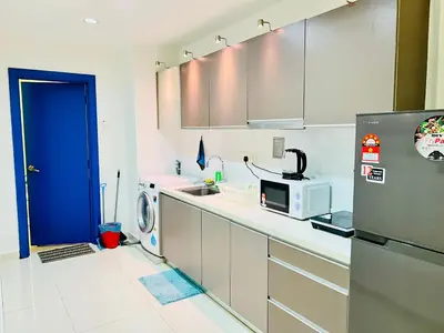 a kitchen with a refrigerator and a microwave at Enjoy your stay Regalia view KLCC in Kuala Lumpur