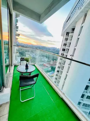 a balcony with a table and chairs on a building at Enjoy your stay Regalia view KLCC in Kuala Lumpur