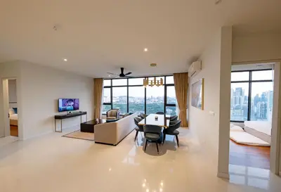 a living room with a table and a couch at La Gente X Pavilion Embassy Serviced Suites in Kuala Lumpur