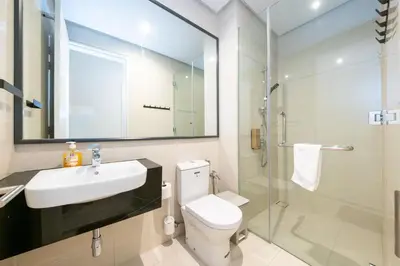 a bathroom with a toilet and a sink and a shower at La Gente X Pavilion Embassy Serviced Suites in Kuala Lumpur