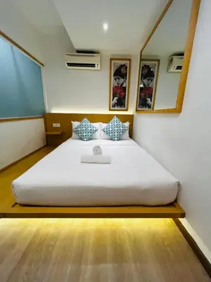 a bedroom with a large white bed in a room at Vivids Hotel Bukit Bintang in Kuala Lumpur