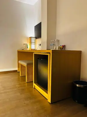 a yellow tv sitting on top of a wooden table at Vivids Hotel Bukit Bintang in Kuala Lumpur