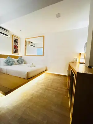 a white room with a bed and a mirror at Vivids Hotel Bukit Bintang in Kuala Lumpur