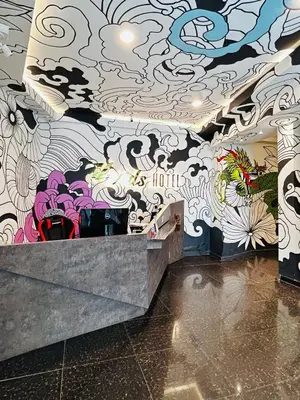 a room with a wall covered in graffiti at Vivids Hotel Bukit Bintang in Kuala Lumpur