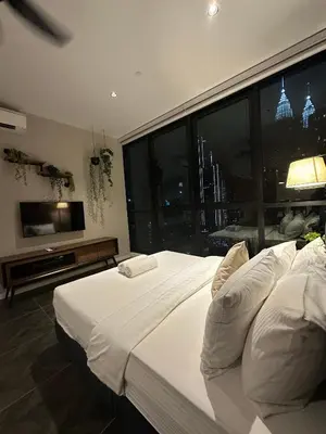 a bedroom with a large white bed and a large window at SKYLINE HOME BY SCARLETZ SUITEs KLCC in Kuala Lumpur