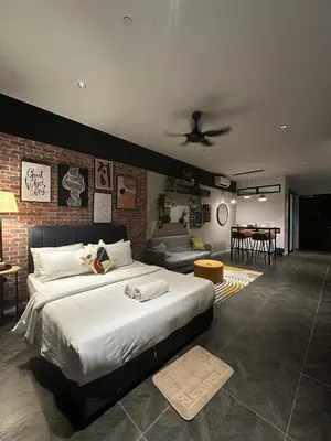 a bedroom with a large bed and a brick wall at SKYLINE HOME BY SCARLETZ SUITEs KLCC in Kuala Lumpur