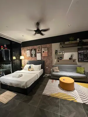 a bedroom with two beds and a ceiling fan at SKYLINE HOME BY SCARLETZ SUITEs KLCC in Kuala Lumpur