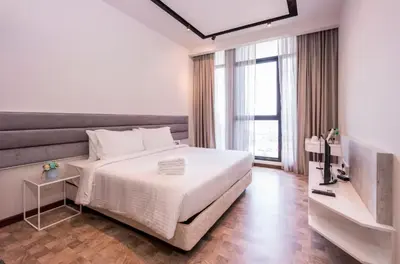 a bedroom with a white bed and a large window at Expressionz Suite KL City Center KLCC in Kuala Lumpur