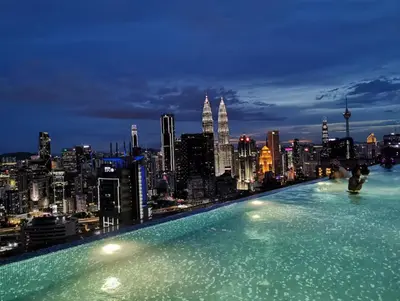 a swimming pool on the roof of a building with a city at Expressionz Suite KL City Center KLCC in Kuala Lumpur